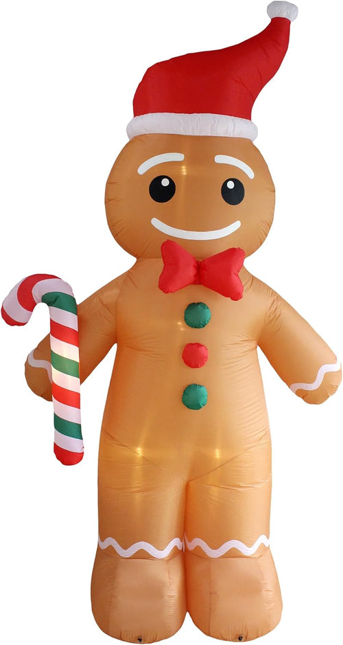 Giant inflatable gingerbread man in a Santa hat holding a candy cane