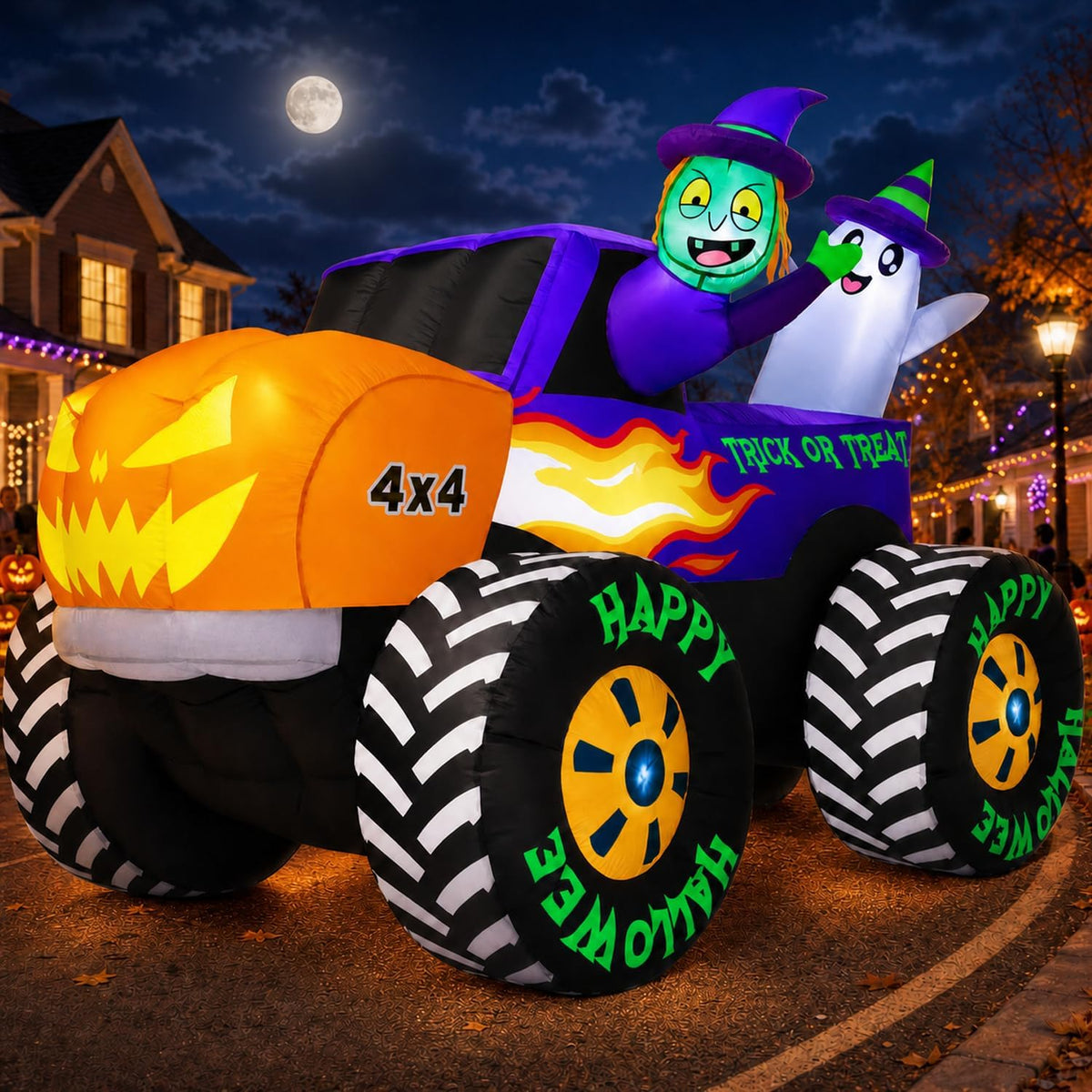 Inflatable orange pumpkin-faced monster truck with a witch and ghost at night