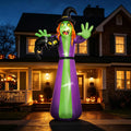 Giant inflatable witch in a purple robe with a black cat at night