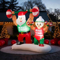 Inflatable Santa and Mrs. Claus lifting barbells in matching shirts