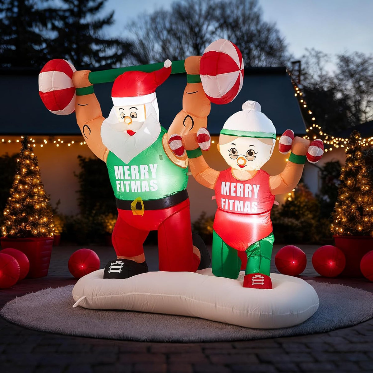 Inflatable Santa and Mrs. Claus lifting barbells in matching shirts