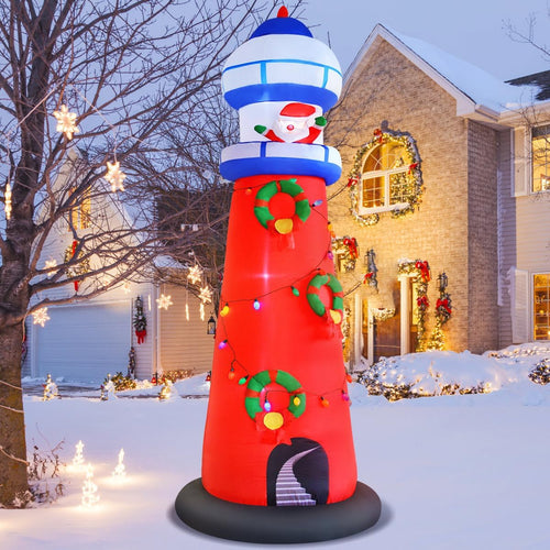 Red and white inflatable lighthouse with Santa at the top in the snow