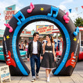 Black inflatable horseshoe arch with music notes over a couple in fifties outfits