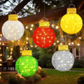 Five glowing pop-up ornament balls hanging from trees