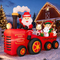 Inflatable Santa driving a red tractor pulling farm animals