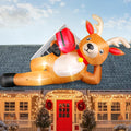Giant inflatable reindeer lying on a roof with a gift box