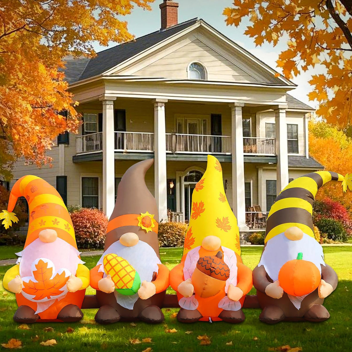 Inflatable group of four fall gnomes with pumpkins in front of a house