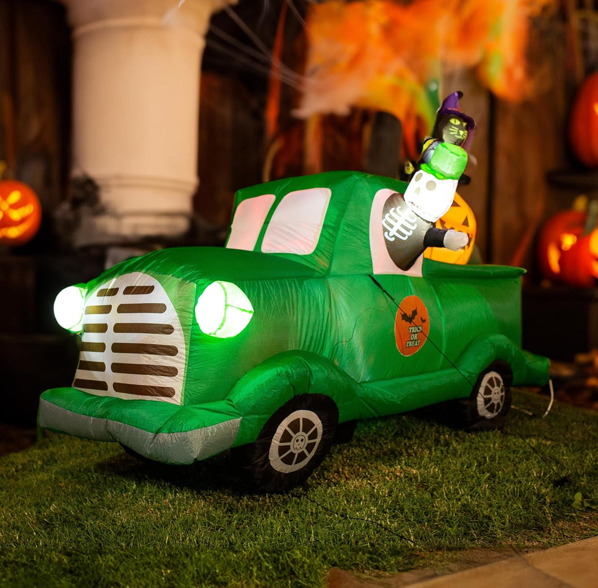 Inflatable vintage green pickup truck driven by a ghost at dusk